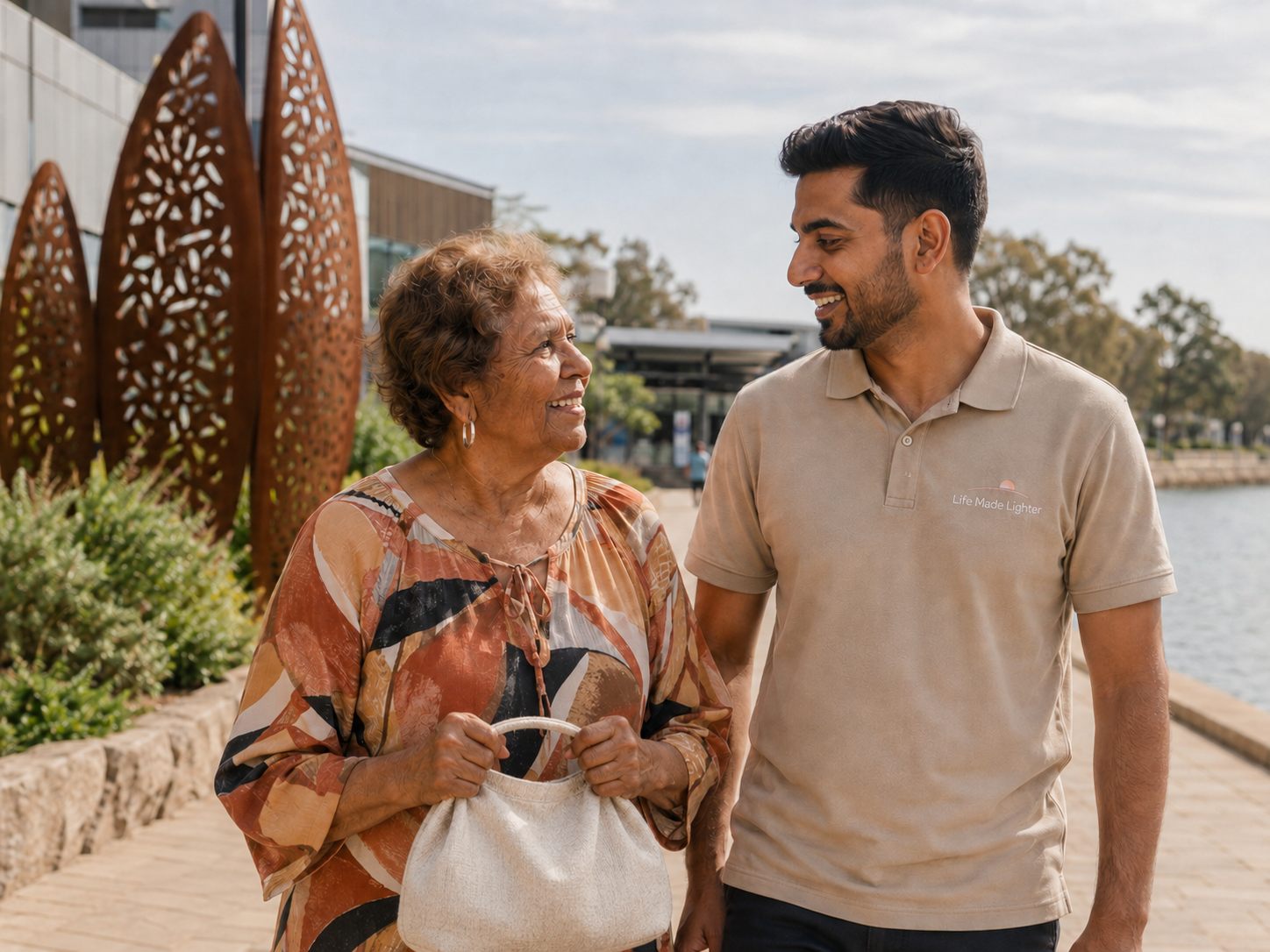 A support worker and client enjoying a walk in the community